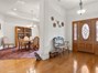 Large, wide foyer with beautiful hardwood floors. Formal dining room to the left,