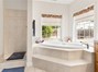 Primary bath with soaking spa tub and walk-in shower.