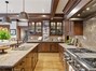 This kitchen has 2 dishwashers, 2 sinks, 2 refrigerators and 6 burner range
