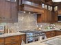 Granite backsplash all the way to the upper cabinets