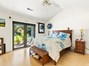 Primary bedroom suite - French doors open out to huge backyard