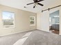 Primary bedroom with barn door to primary bathroom.