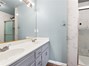 Main bathroom upstairs with double sinks and walk-in shower.