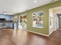 View of kitchen and opens up to family room with sliding door going out to the backyard area and entrance to the 4th bedroom.