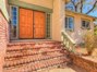 A lovely brick staircase leads to the double-door entry and welcoming foyer.
