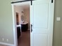Barn door accent from main bedroom to bathroom