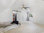 Primary bedroom featuring new carpet, ceiling fan and bathroom