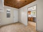 View from the utility room into the kitchen. Exterior door provides direct access to the backyard