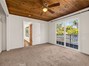 A bedroom retreat with charming wood ceilings and sliding glass doors to your own private deck!