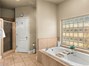 Large primary bath with soaking tub and walk in shower.