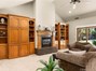 Custom built-in, fresh carpet and high ceilings round out this beautiful living room.