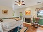 Primary suite with fireplace and balcony.
