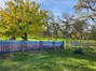 Custom hand-painted purple mountain fence, driveway and front yard view