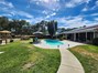 View from detached converted garage of the pool and back patio of main house