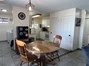 Dining room featuring a textured ceiling, washing machine and clothes dryer, and dark tile patterned floors