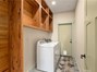 Laundry room with cabinets, washer dryer and door to back deck