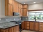 Kitchen with garden window, custom cabinets, Whirlpool gas range and microwave