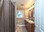 Full bathroom with dual sinks & tub/shower