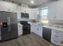 View of kitchen with refrigerator included.