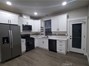 View of kitchen with refrigerator included.