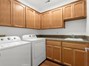 Tons of storage cabinets in the laundry room, located right off the kitchen!