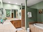 Primary Bathroom with Dual Vanities, Soaking Tub and Tiled Walk-In Shower.