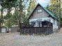 Front of cabin with garage and storage