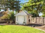 Cute storage shed painted to match the home!
