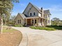 House entrance with covered porch and brick patio