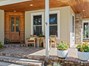 Front porch with glass door into kitchen nook.